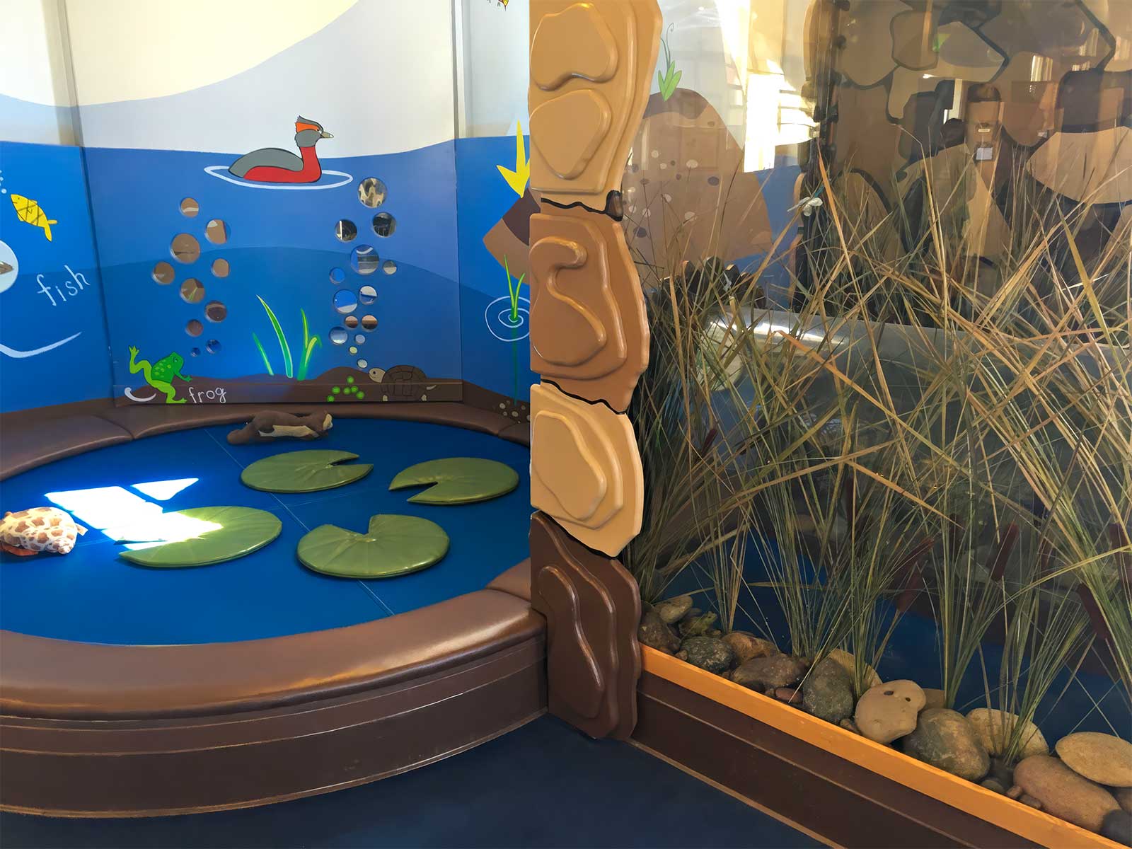  Under the Lily Pad | Bay Area Discovery Museum | Acrylic crawl-through cylinder integrated into padded play environment 