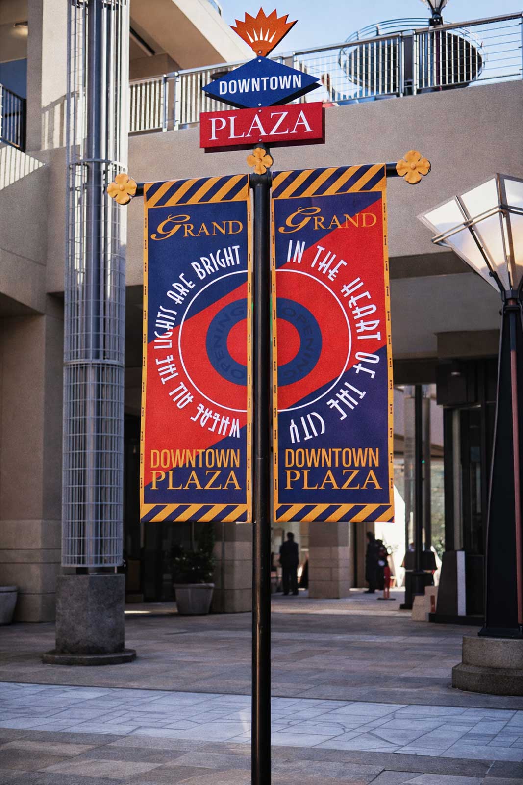  Identity Banners and Stands | Downtown Plaza | Opening banners and custom permanent stands with waterjet cut aluminum logo shapes 