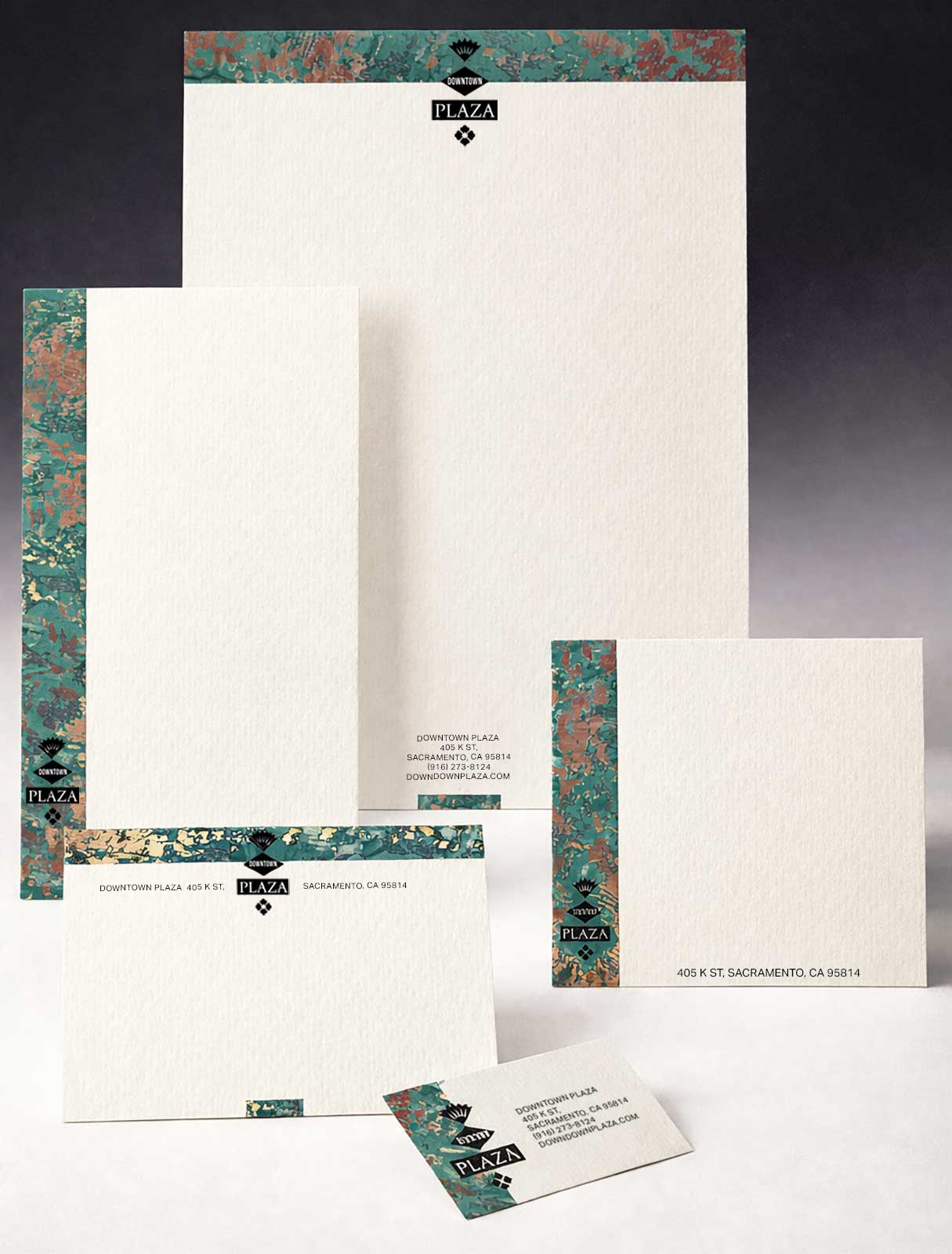  Stationery System | Downtown Plaza | Letterhead system reinforcing the custom mark and verdigris copper texture 