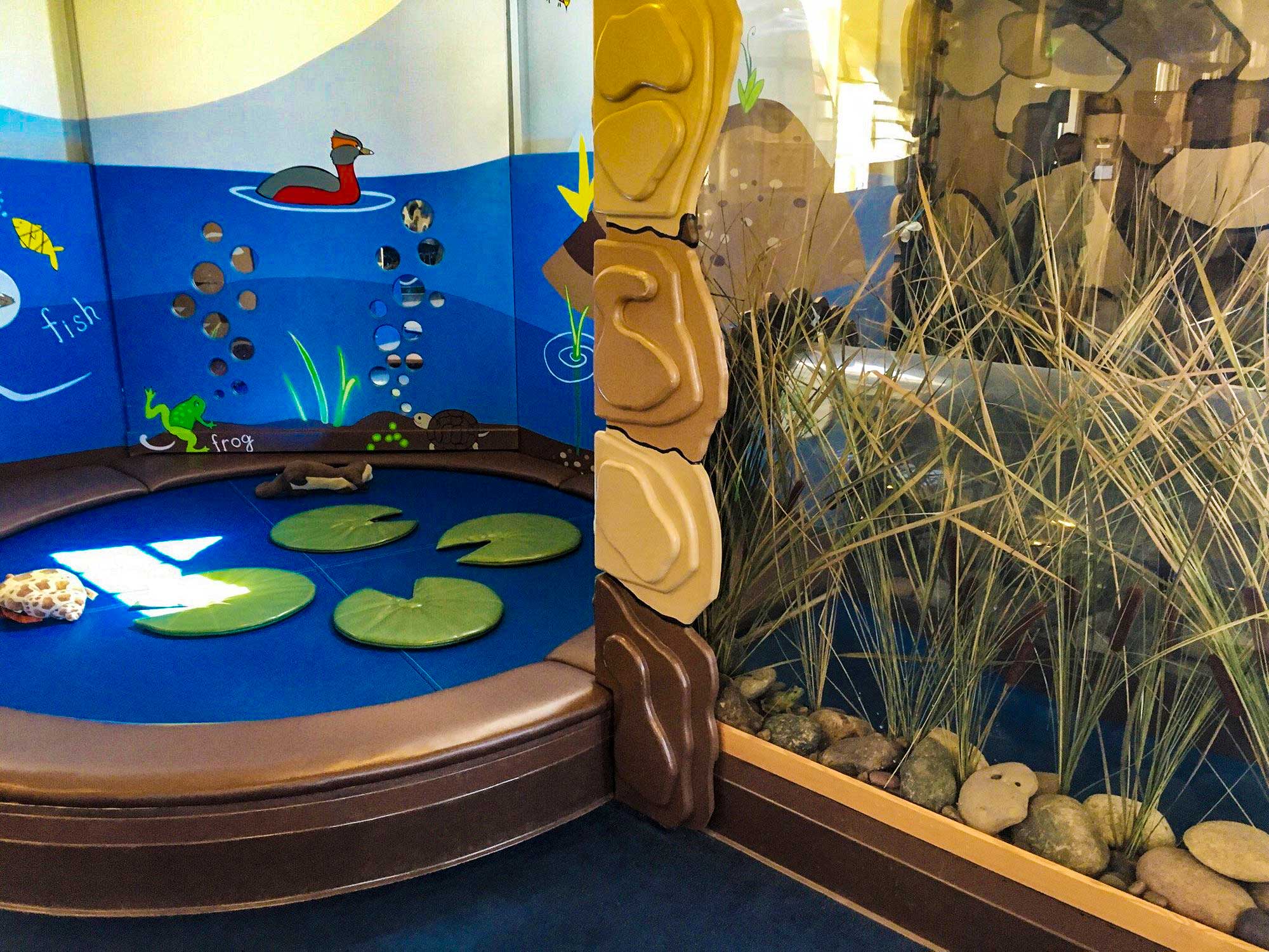  Under the Lily Pad | Bay Area Discovery Museum | Acrylic crawl-through cylinder integrated into padded play environment 